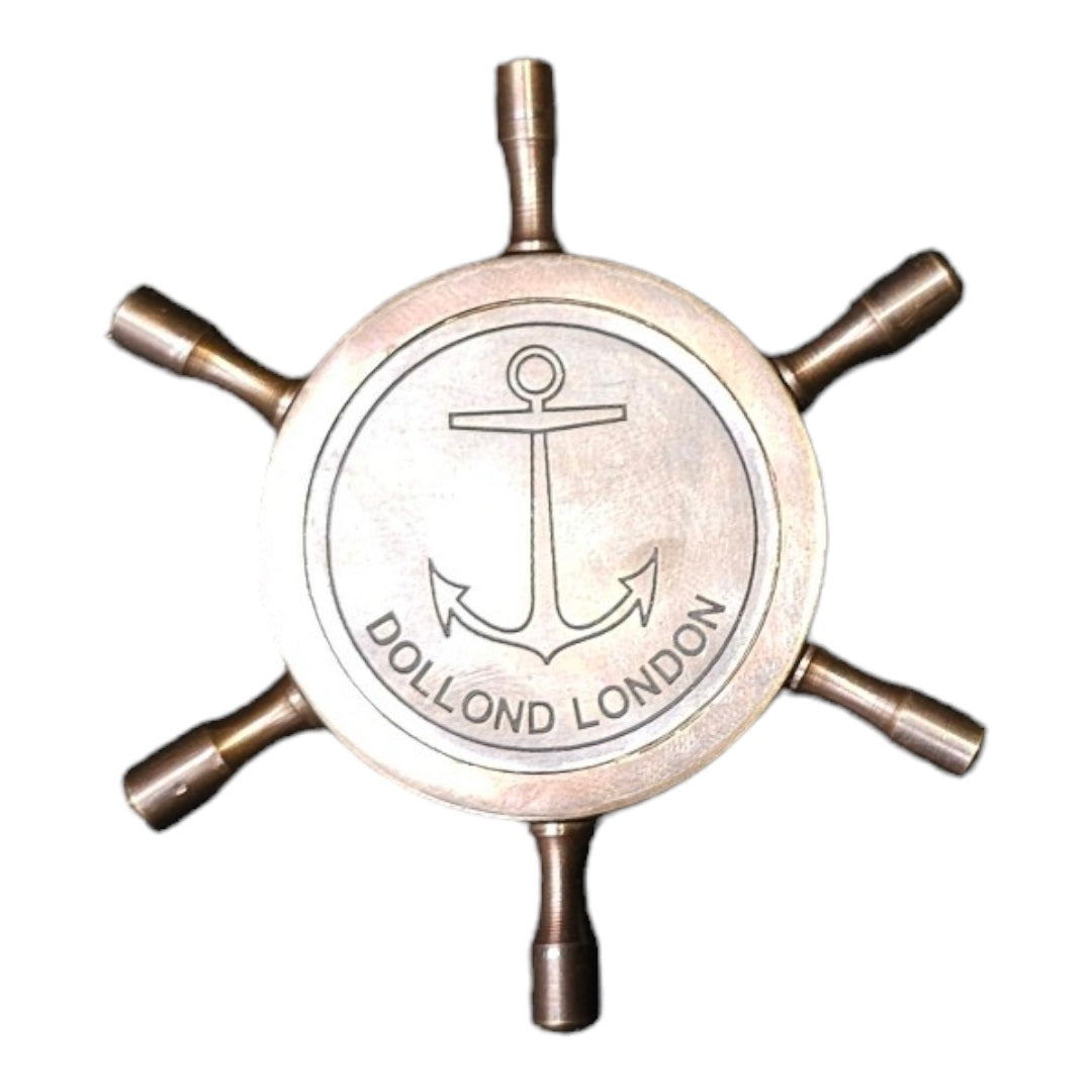 Brass compass displayed backside Dollond London, ideal for hiking, camping, and adventure.