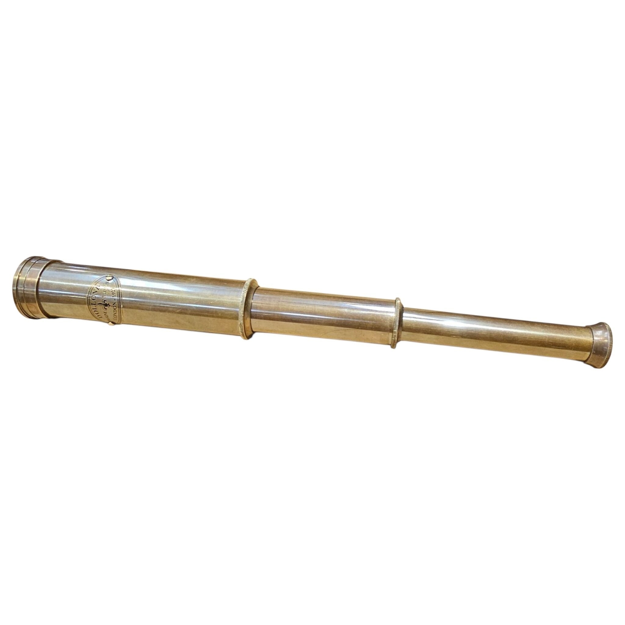Fully extended 12 inch collapsible brass telescope on a white background
