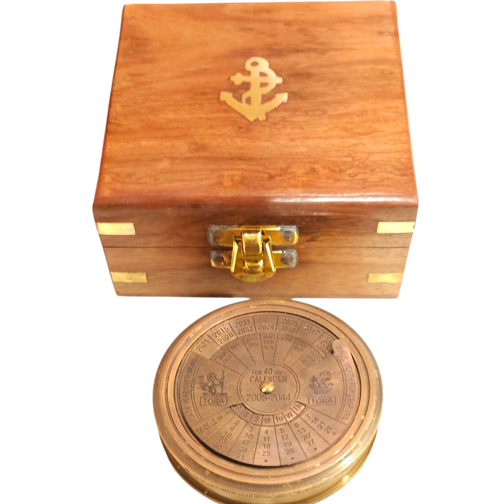 Wooden box with a gold anchor emblem and a brass calendar compass on a white background