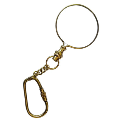 Gold metal keychain with a magnifying glass on a white background