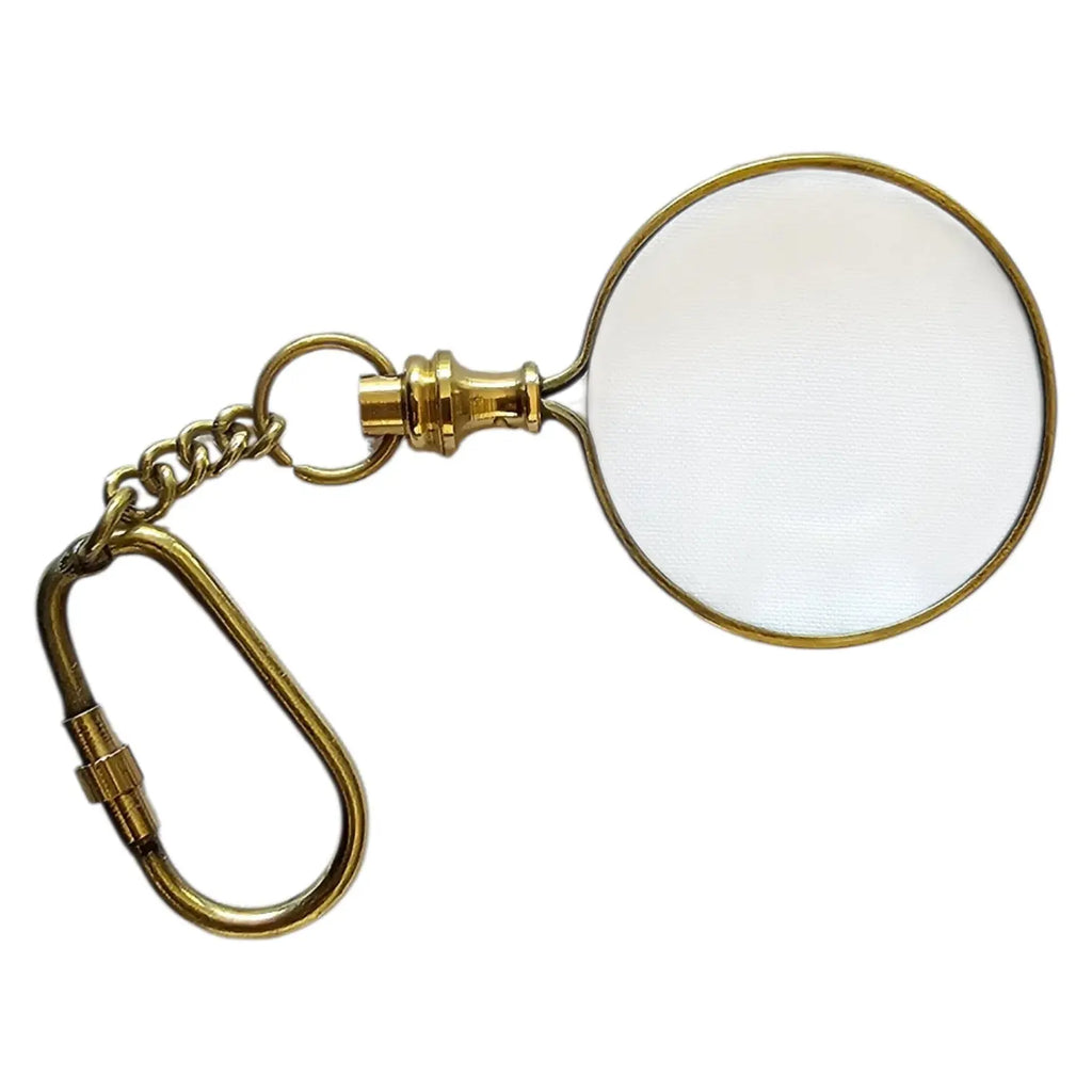 Gold magnifying glass keychain on a white background