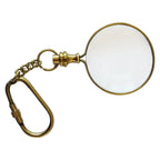 Gold magnifying glass keychain on a white background