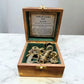 Vintage sextant in a wooden box on a marble surface