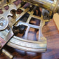 Close-up of a brass sextant on a wooden surface