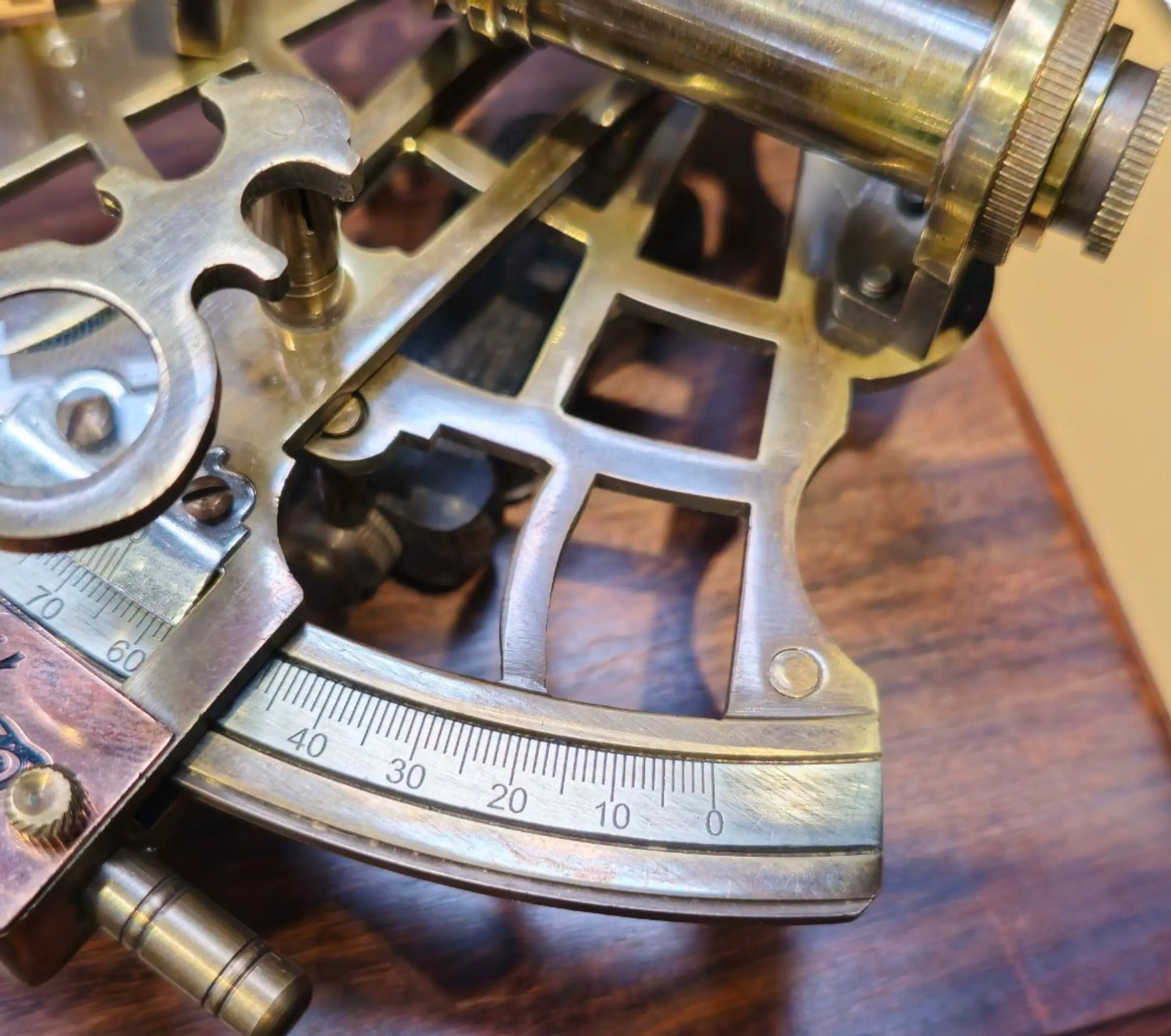 Close-up of a brass sextant on a wooden surface