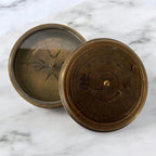 mypirateshop vintage brass perpetual calendar compass with an antique patina finish on a white marble surface