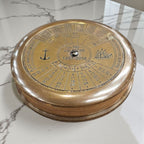 mypirateshop vintage brass perpetual calendar compass with anchor engraving and 100-year date display on marble surface
